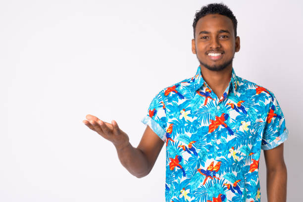 istock Happy young handsome African tourist man showing something 1189489267