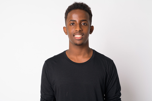 Studio shot of young African man with Afro hair against white background