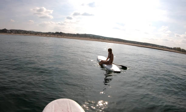 istock young woman stand up paddle board sea 1189492289