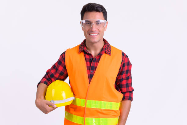 istock Young happy Hispanic man construction worker with protective glasses smiling 1189494441
