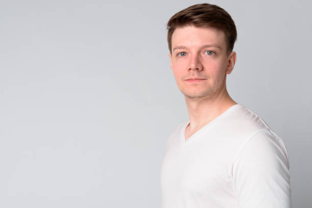 istock Profile view of young handsome man looking at camera 1189495261