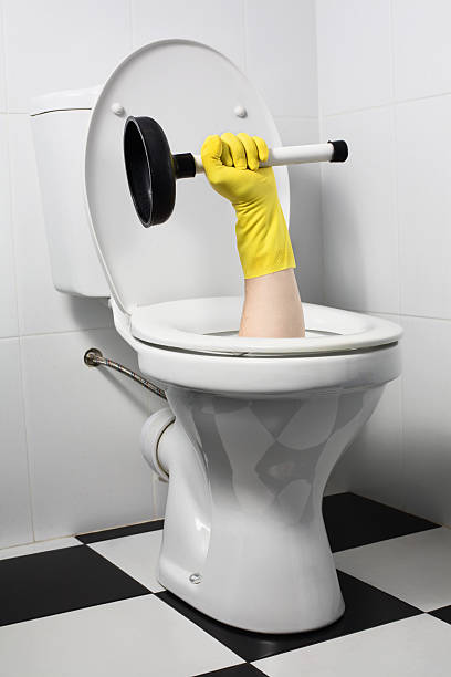 unusual plumber with plunger (joke) stock photo