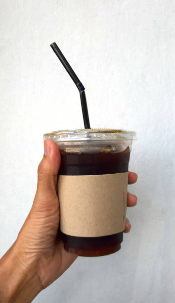istock hand holding a Coffee cup,watering  in cup 1189499266