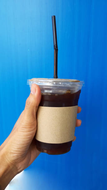 istock hand holding a Coffee cup,watering  in cup 1189499267