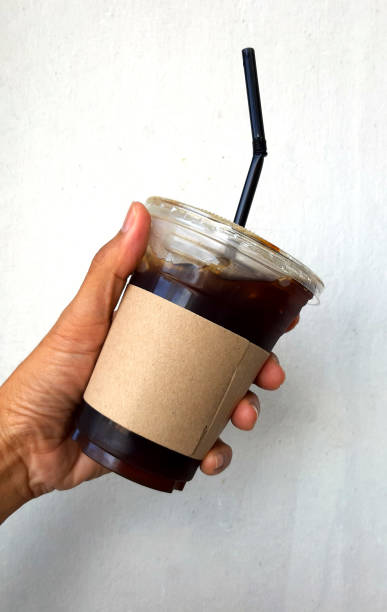 istock hand holding a Coffee cup,watering  in cup 1189499283