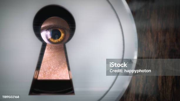 A Man Looks Through A Keyhole Closeup Stock Photo - Download Image Now - Keyhole, Looking Through An Object, Eye