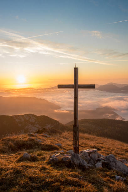 big cross next to morning sun, mountain ogradi, bohinj - summit cross imagens e fotografias de stock