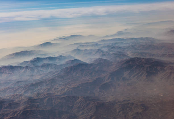 Aerial view of misty mountains seen from airplane