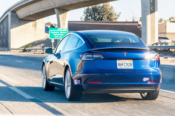 Tesla Model 3 driving on the freeway Nov 2, 2019 Mountain View / CA / USA - Tesla Model 3 driving on the freeway in San Francisco bay area tesla model 3 stock pictures, royalty-free photos & images