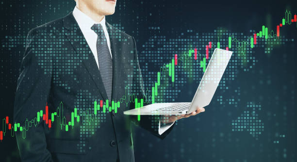 istock Businessman traider with laptop and digital screen with forex graphs and pixel world map.Double exposure. 1189505997