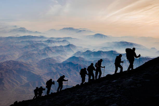 istock Silhouettes of hikers At Sunset 1189506117