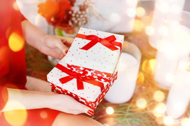 istock Women hold boxes with a New Year's gift. 1189506996