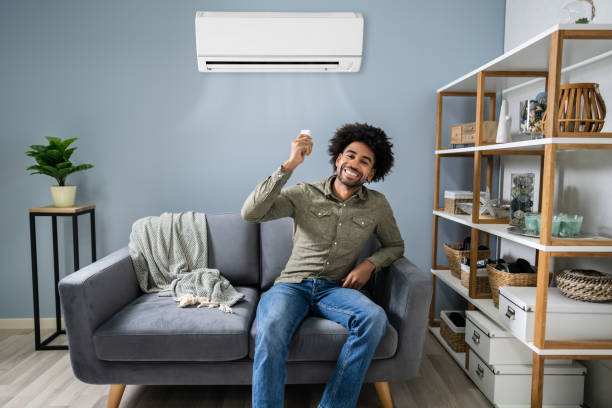 istock Man Adjusting The Temperature Of Air Conditioner 1189507390