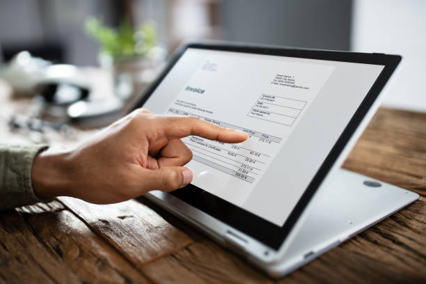 istock Businessman's Hands Working On Invoice On Laptop 1189508104