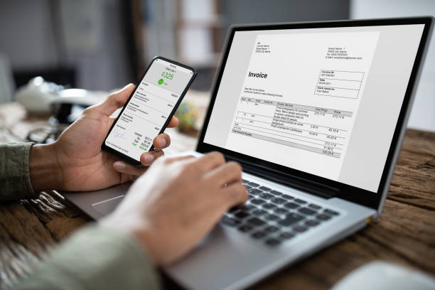 istock Businessman's Hands Working On Invoice On Laptop 1189508113