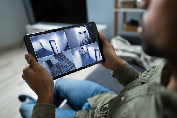 istock Businessman Looking At CCTV Camera Footage On Digital Tablet 1189508142