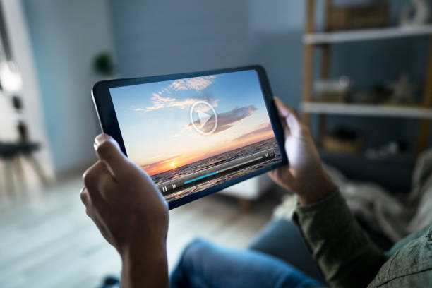 istock Man Watching Movie On Digital Tablet 1189508195