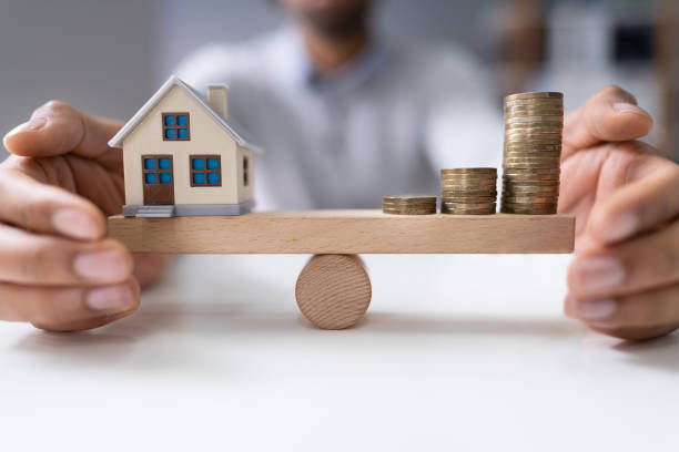 istock Protecting Balance Between House Model And Stacked Coins 1189508294