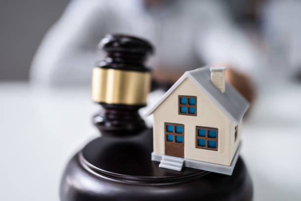 istock Judge Holding Gavel With House Model 1189508307
