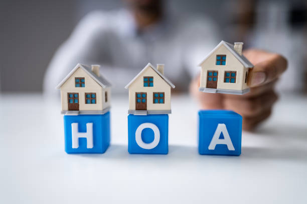istock Businessperson Placing House Model Over Hoa Blocks 1189508313