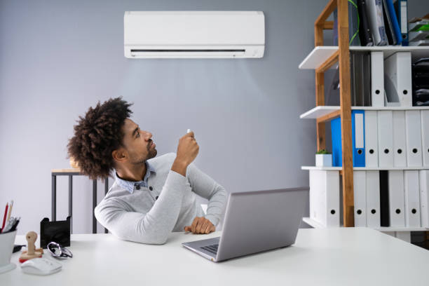 istock Businessman Operating Air Conditioner 1189508422