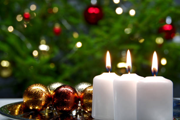 istock three burning candles with Christmas decoration. xmas composition. 1189508455