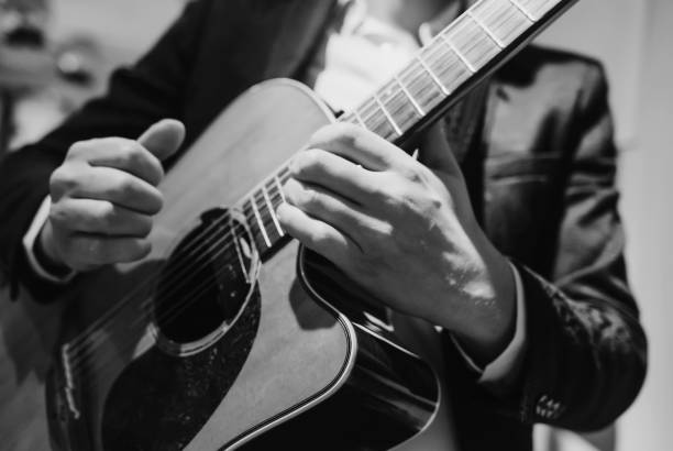 black and white photo of a musician playing guitar