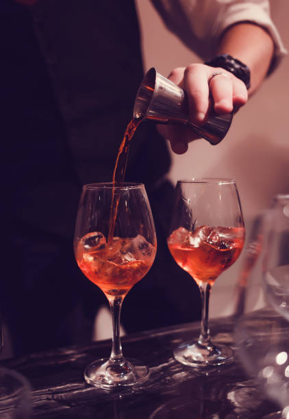 istock bartender pours sweet syrup into a glass with ice 1189510391