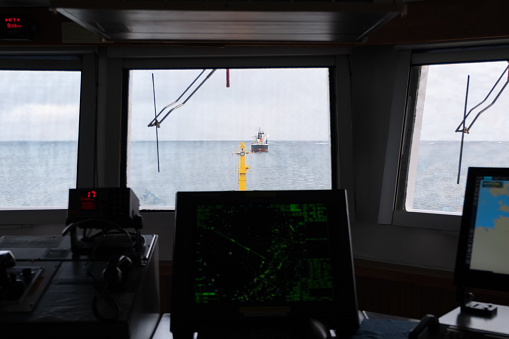 View from pilot house on the vessel which is ahead through illuminator.