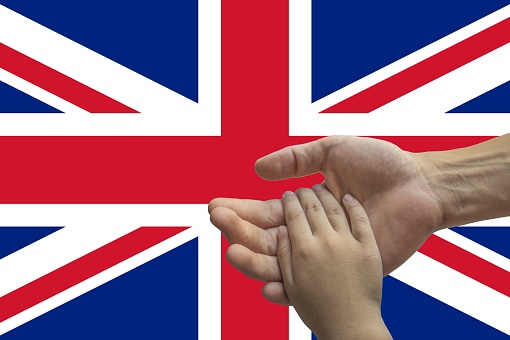 united kingdom flag, intergration of a multicultural group of young people.