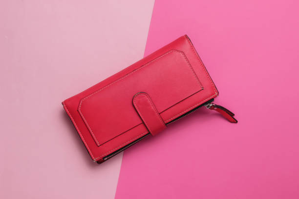 istock Red leather wallet on two-ton pink pastel background. Top view 1189514517