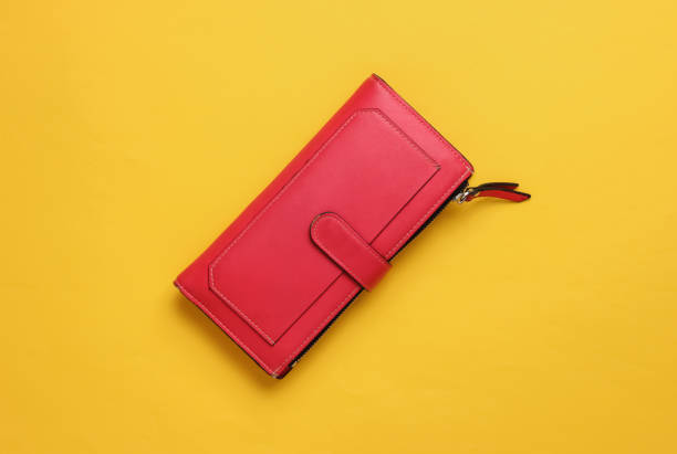 istock Red leather wallet on yellow background. Top view 1189515148