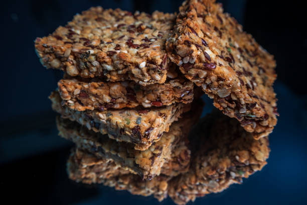 istock Salted cookies with healthy seeds with reflection on shiny black background 1189515232