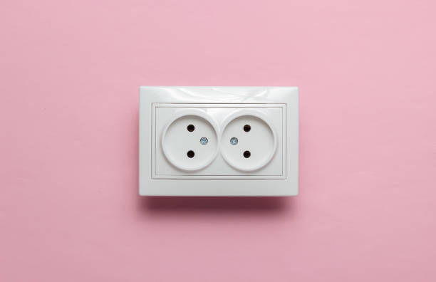 istock Double power socket on pink wall. Studio shot. Minimalism 1189515274