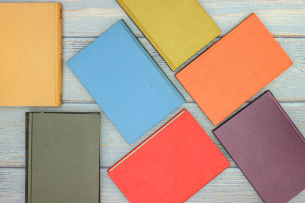 istock Colored books on wooden background 1189516175
