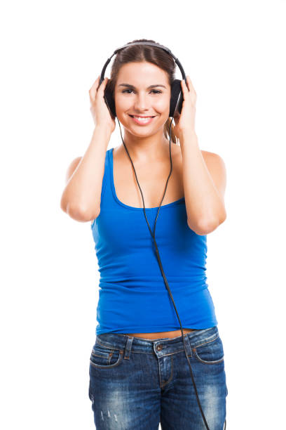 Beautiful woman listen music with headphones, isolated over a white background