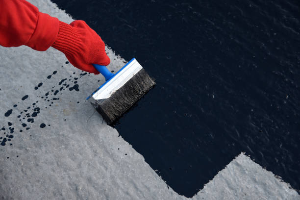 istock Worker applies bitumen mastic on the foundation 1189522658