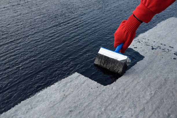 istock Worker applies bitumen mastic on the foundation 1189522823