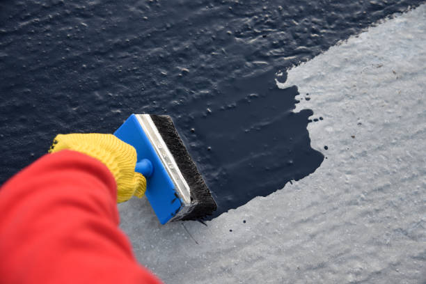 istock Worker applies bitumen mastic on the foundation 1189522827