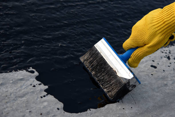 istock Worker applies bitumen mastic on the foundation 1189522845