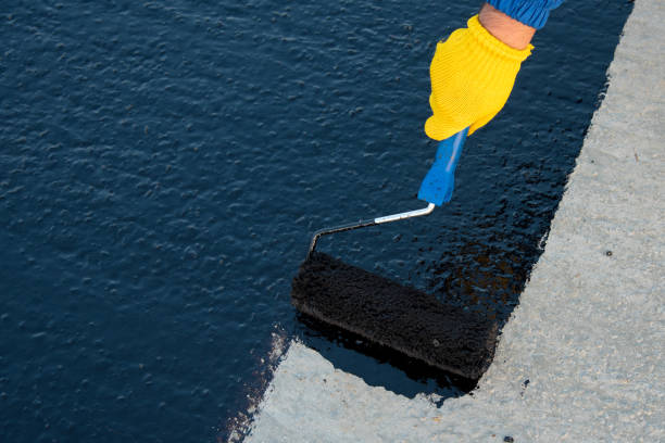 istock Worker applies bitumen mastic on the foundation 1189522847