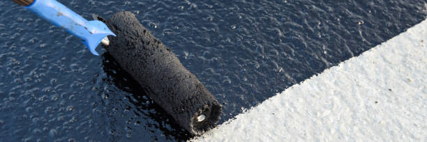 istock Worker applies bitumen mastic on the foundation 1189522857