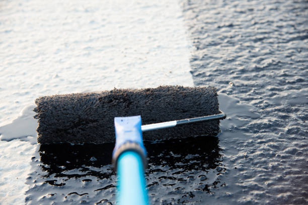 istock Worker applies bitumen mastic on the foundation 1189522863