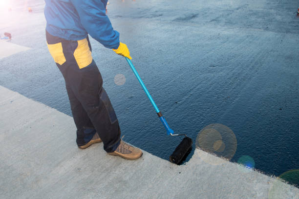 istock Worker applies bitumen mastic on the foundation 1189522869