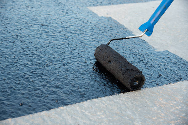 istock Worker applies bitumen mastic on the foundation 1189522907
