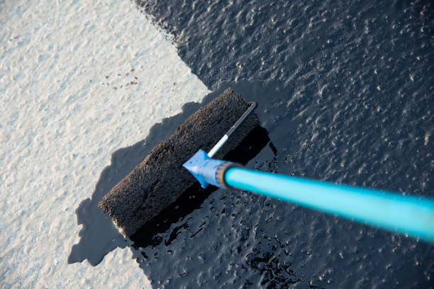 istock Worker applies bitumen mastic on the foundation 1189522932