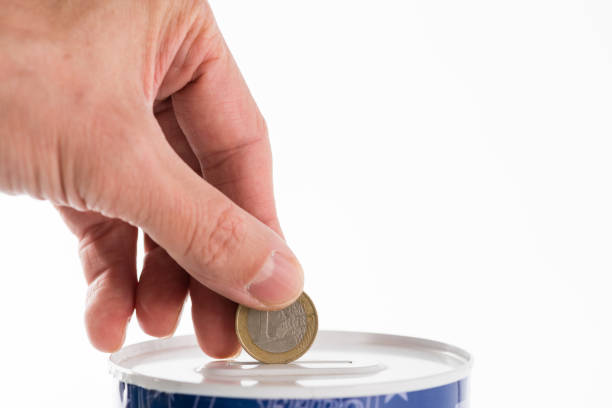 istock Male hand putting a coin into tin can saving bank 1189525931