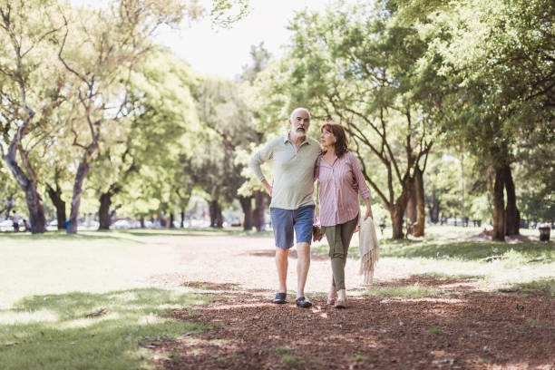 istock Senior couple walking in a park 1189531334