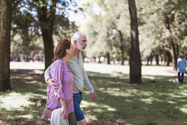 istock Senior couple walking in a park 1189531380