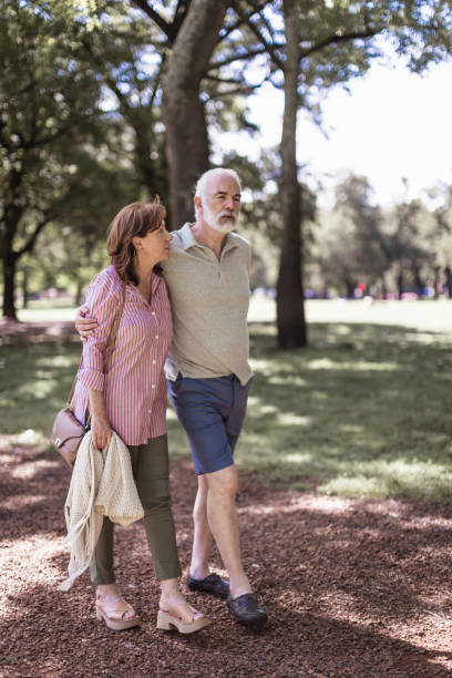 istock Senior couple walking in a park 1189531381